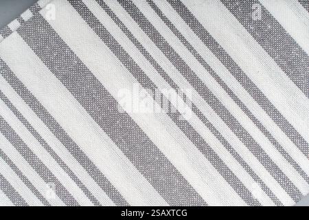 Background with the texture of cotton fabric in diagonal gray and white stripes. Laconic design, background pattern. High quality photo Stock Photo