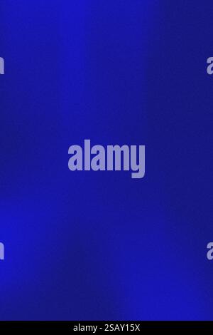 Abstract background with grainy shimmering dark blue indigo color. Color gradient. Texture with noise and grain creates an effect of depth and natural Stock Photo