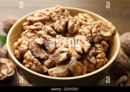 Peeled walnuts in bowl on table, closeup Stock Photo