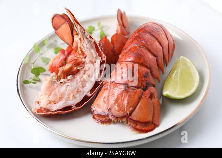 Delicious tails of boiled lobsters served on white table, closeup Stock Photo