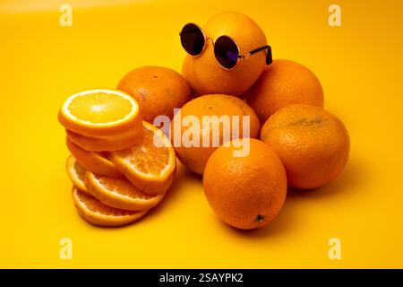 Top view of orange with sunglasses sitting on top of orange and sliced orange Stock Photo