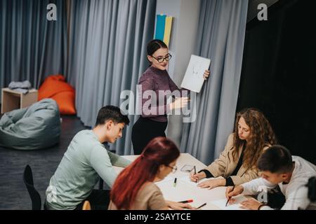 Teacher guiding students during an interactive classroom session Stock Photo