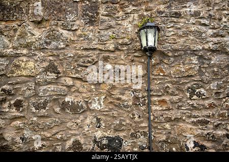 Background photography of old grunge wall with  lantern; fence, concrete and stones, grey abstract textured pattern, obsolete Stock Photo