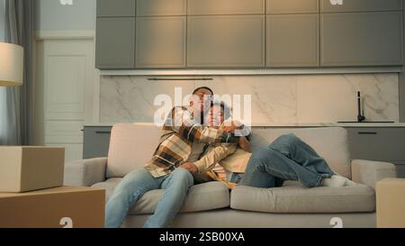 Happy African american family man woman home owners buy rent house repair apartment moving day relocation day unpacking furniture sofa delivery joyful Stock Photo
