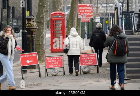London, UK. Pedestrians ignoring signs directing them across the road Stock Photo