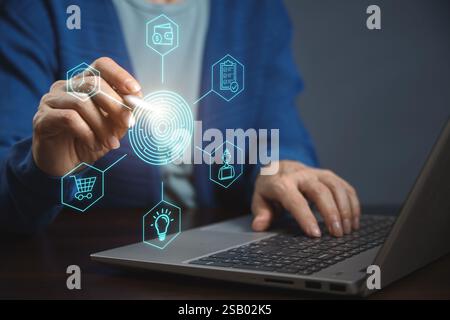 A person is working on a laptop, interacting with virtual icons on the screen. The icons represent various functions and tools. Corporate strategy for Stock Photo