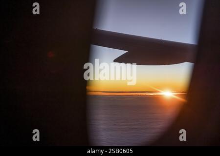 View of the Persian Gulf from the aeroplane window in the evening. Sunset over the clouds. Flight with the airline Etihad. Abu Dhabi, United Arab Emir Stock Photo