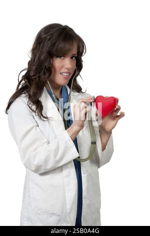 Beautiful young woman cardiologist doctor holding a heart Stock Photo