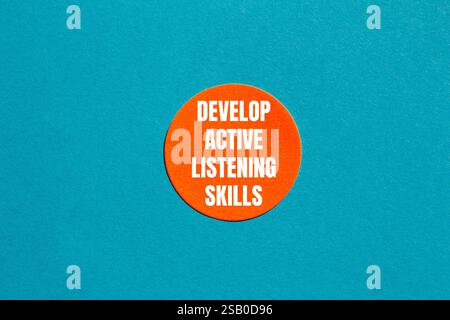 Develop active listening skills message written on ripped torn yellow ...