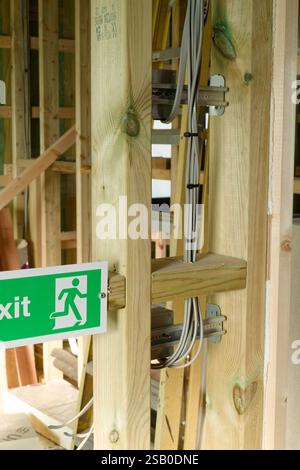 The first fix by electricians in wiring a property. New build wire installation to junction boxes, sockets and switches. Stock Photo
