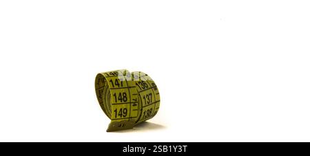 Rolled tailor's meter, measuring tape on a white background. Stock Photo