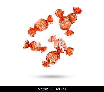 Candies in bright wrappers falling on white background Stock Photo