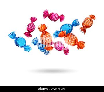 Candies in bright wrappers falling on white background Stock Photo