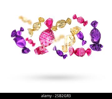 Candies in bright wrappers falling on white background Stock Photo