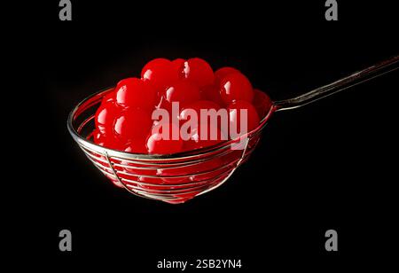 red jelly balls for making bubble tea in a strainer on grey background Stock Photo
