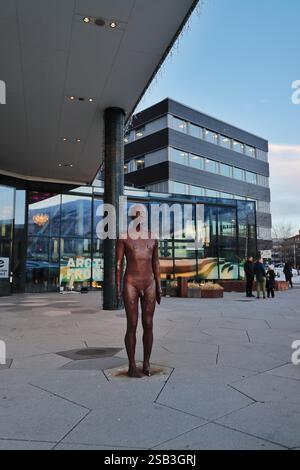 An Anthony Gormley statue at the Clarion Hotel in Tromso, Norway, depicting a lifelike standing figure in bronze, in the artist's signature style Stock Photo