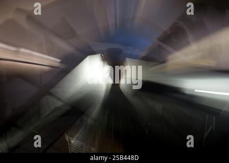 A surreal, nighttime scene featuring an outdoor patio with a large ceramic vase, a dining table, and a small illuminated pool. Stock Photo
