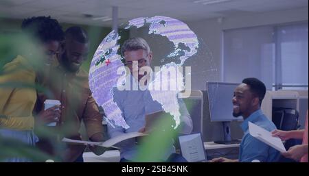 Digital globe image over diverse business team collaborating in modern office Stock Photo