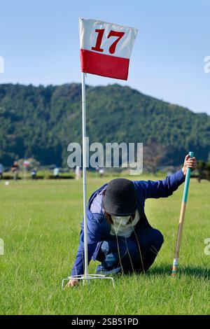 Old japanee woman playing gate ball at the gate 17 on gateball field Stock Photo