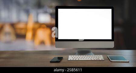 A computer monitor sits on a desk Blank screen desktop computer in minimal room with copy space Stock Photo