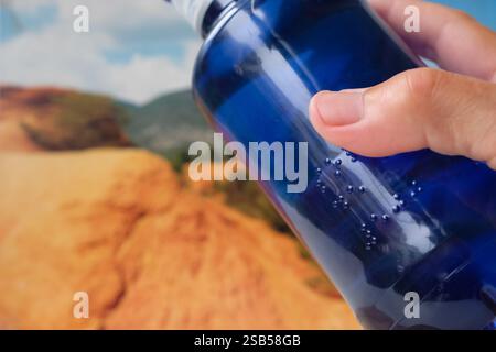 Braille font on a plastic water bottle. Raised dots on the plastic bottle. Braille printing for plastic packaging. Copy space. Stock Photo
