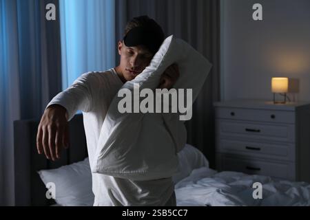 Young man suffering from sleepwalking at home Stock Photo