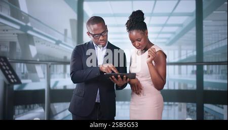 Businesspeople Discussing Standing Inside Elevator At Work Stock Photo