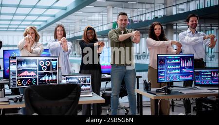 Innovative Business Professionals Engaging in Desk Yoga Session Together Stock Photo