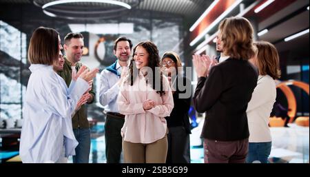 Office Celebration: Diverse Team Congratulating Employee on Professional Achievement Stock Photo