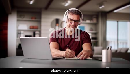 College Teacher At Home Using Laptop Computer Stock Photo