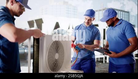 diverse group of workers inspecting and installing commercial HVAC. Stock Photo