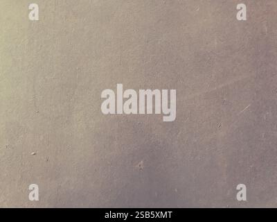 Grey wall with a few scratches and marks. The wall is made of concrete and has a rough texture Stock Photo