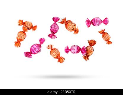 Candies in bright wrappers falling on white background Stock Photo