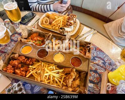 Large beer plate, large set of beer snacks. assorted snacks deep-fried beer. Food for a holiday for a large company. hot meat snacks for beer served o Stock Photo