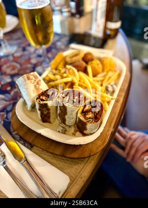 Large beer plate, large set of beer snacks. assorted snacks deep-fried beer. Food for a holiday for a large company. hot meat snacks for beer served o Stock Photo