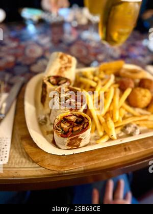 Large beer plate, large set of beer snacks. assorted snacks deep-fried beer. Food for a holiday for a large company. hot meat snacks for beer served o Stock Photo