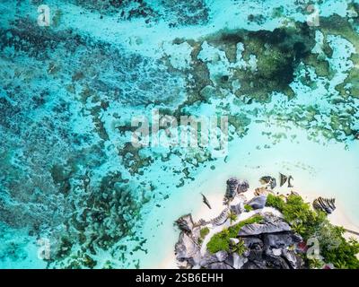 Aerial view of Anse Source D'Argent, showcasing turquoise waters, coral formations, and large granite rocks along the white sandy coastline on La Digu Stock Photo
