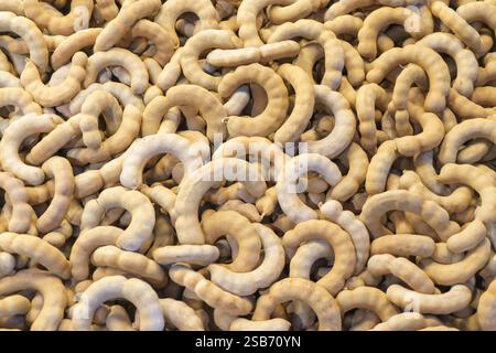 close-up shot of fresh tamarind pods displayed in bulk. The naturally curved shapes and earthy brown tones of the tamarind create a rustic and organic Stock Photo