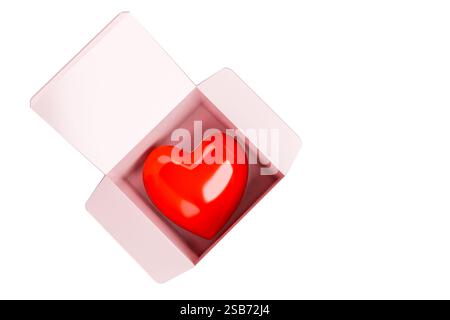 A glossy red heart placed inside an open pink gift box on a clean white background. Ideal for romantic themes, Valentine's Day concepts, love gift des Stock Photo