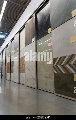 Modern store interior. Bathroom tiles and utensils shopping. Displays of granite and ceramic tile samples at the big construction store. Selective foc Stock Photo