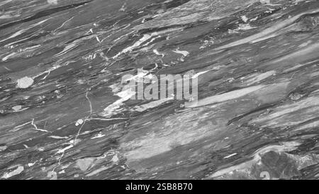 background of a stone wall with a gray and white pattern. The wall looks like it is made of marble and has a rough texture. The photo creates a sense Stock Photo