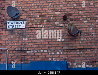 A street sign high up on a brick wall on Gwladys Street next to Goodison Park in Liverpool, UK Stock Photo