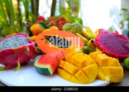 Thai Fresh Exotic Fruits (Pineapple, Coconut, Mango, Rambutan, Masngosteen, Dragon Fruit, Rose Apple, Sugar Apple, Snake Fruit) on the Table. Healthy Vitamin Nutritious Food.  Stock Photo