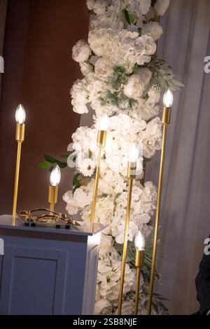Candle light in the night. wedding flower set up with white orchid and gold candle Stock Photo