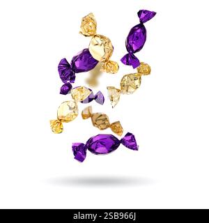 Candies in bright wrappers falling on white background Stock Photo