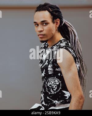 A male photo model with swarthy skin and long dreadlocks at the Photo Forum in Moscow, Russia April 13, 2019 Stock Photo