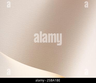 A beige paper background with a textured surface, featuring soft tones and gentle curves with subtle folds. The interplay of light and shadows enhance Stock Photo