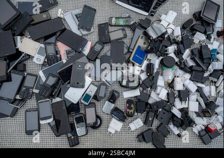 Hunedoara, Romania - January 25, 2025: Crowd of people and various objects, toys, tools and electronics at a flea market. Stock Photo