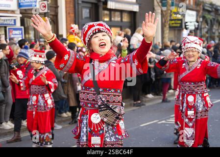 Chinese New Year Parade along the streets of London. People in colourful costumes having fun celebrating the year of the snake. London - 2nd February Stock Photo