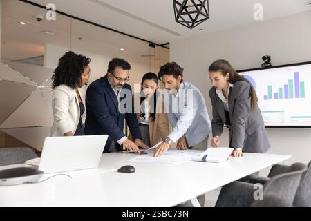 Diverse business team of serious colleagues analyzing financial reports Stock Photo
